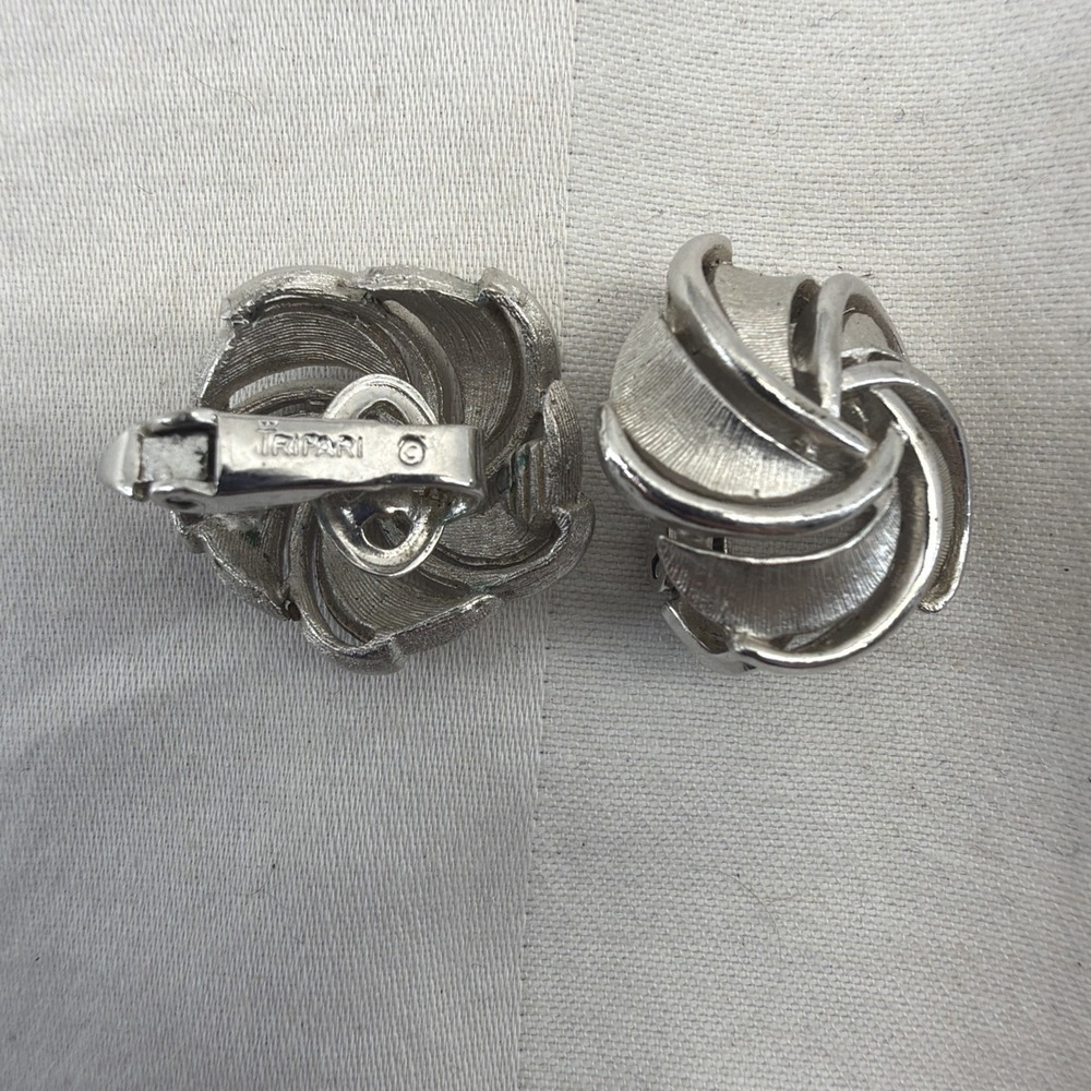 These are vintage silver-tone Trifari twist clip-on earrings